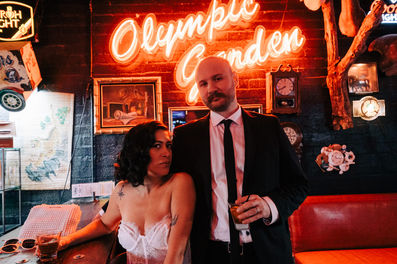 bride and groom pose for photos at a dive bar in las vegas captured by las vegas elopement photographer brazen honey films