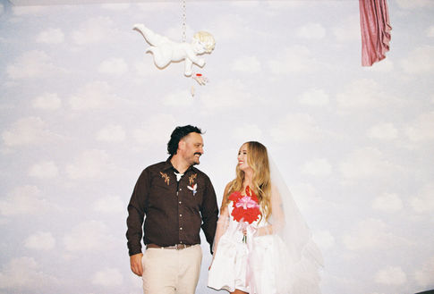 35mm film photo by las vegas elopement photographer brazen honey films. couple gets married at sure thing chapel with pink vintage vibes.