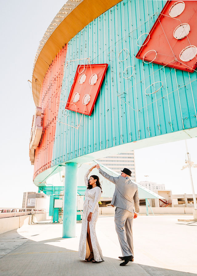 Las Vegas 50's style elopement. Couple has their first look on a rooftop parking garage in Las Vegas captured by las vegas elopement photographer brazen honey films.