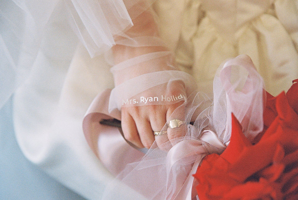 35mm film photo by las vegas elopement photographer brazen honey films. couple gets married at sure thing chapel with pink vintage vibes.