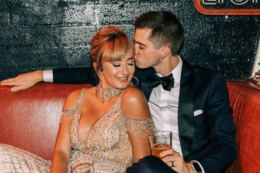 Bride and groom share a drink in a grungy dive bar in downtown las vegas on their wedding day. Captured by las vegas elopement photographer brazen honey films