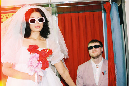Las vegas elopement film photographer captures weddings on 35mm film. Vegas kitsch wedding vibes at the sure thing chapel. Analog photobooth in downtown las vegas. 