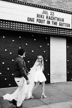 35mm film photo by las vegas elopement photographer brazen honey films. couple takes pictures in downtown las vegas with neon lights and vintage vibes.