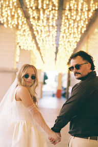 35mm film photo by las vegas elopement photographer brazen honey films. couple takes pictures in downtown las vegas with neon lights and vintage vibes.