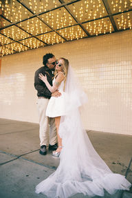 35mm film photo by las vegas elopement photographer brazen honey films. couple takes pictures in downtown las vegas with neon lights and vintage vibes.