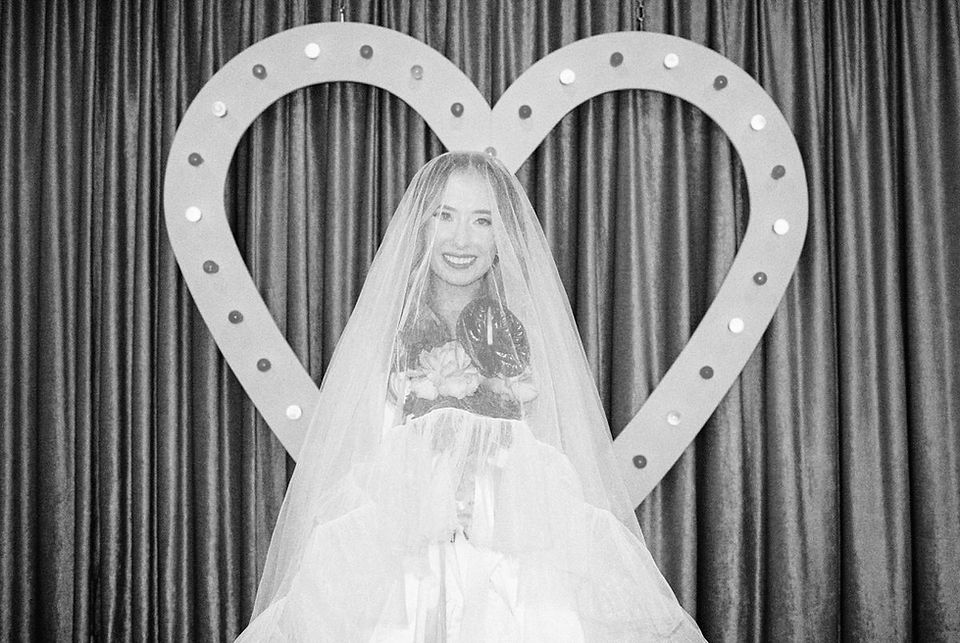 35mm film photo by las vegas elopement photographer brazen honey films. couple gets married at sure thing chapel with pink vintage vibes.