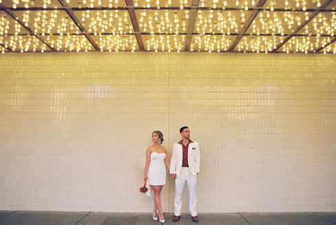 Kitsch elopement at the little white wedding chapel in las vegas shot on 35mm film. Neon lights wedding portraits by wedding photographers brazen honey films