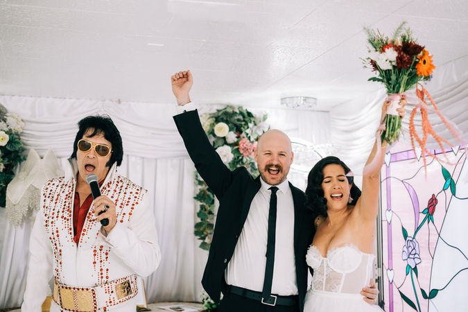 bride and groom recite wedding vows at the little white wedding chapel in las vegas. elvis wedding officiant captured by las vegas elopement photographer brazen honey films