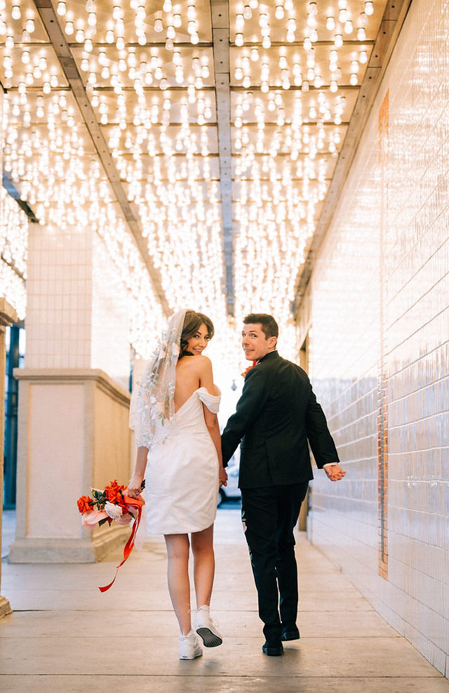 Las Vegas wedding photographer brazen honey films captures an epic elopement at sure thing chapel with elvis officiant. Photoshoot at the neon museum and downtown las vegas with neon lights.