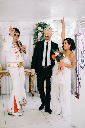 bride and groom recite wedding vows at the little white wedding chapel in las vegas. elvis wedding officiant captured by las vegas elopement photographer brazen honey films