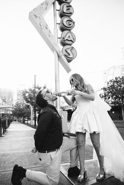 35mm film photo by las vegas elopement photographer brazen honey films. couple takes pictures in downtown las vegas with neon lights and vintage vibes.