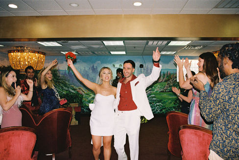 Kitsch elopement at the little white wedding chapel in las vegas shot on 35mm film. Neon lights wedding portraits by wedding photographers brazen honey films