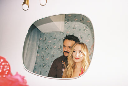 35mm film photo by las vegas elopement photographer brazen honey films. couple takes pictures in downtown las vegas with neon lights and vintage vibes.