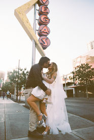 35mm film photo by las vegas elopement photographer brazen honey films. couple takes pictures in downtown las vegas with neon lights and vintage vibes.