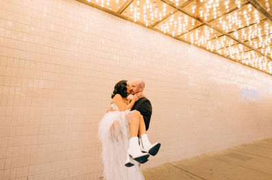 Bride and groom kiss under the neon lights in downtown las vegas, captured by las vegas wedding photographer brazen honey films