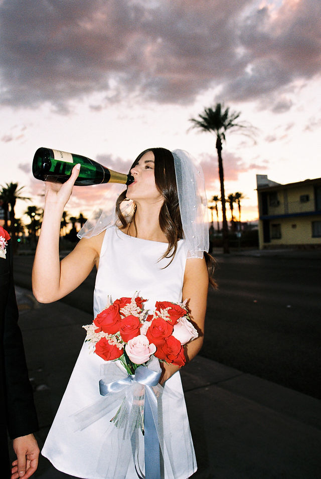 Las Vegas elopement film photographer brazen honey captures vintage inspired elopement at the little white wedding chapel. Wedding photos captured on 35mm film in downtown vegas under the neon lights.