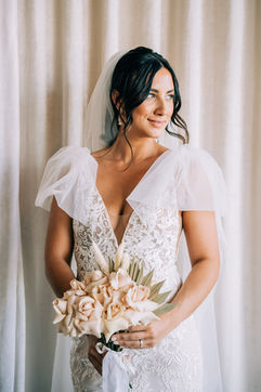 Bride poses for photos at the sure thing chapel wearing beautiful lace dress with bridal cape. Groom stands at the altar at the sure thing chapel waiting for his bride. Captured by las vegas elopement photographer brazen honey films
