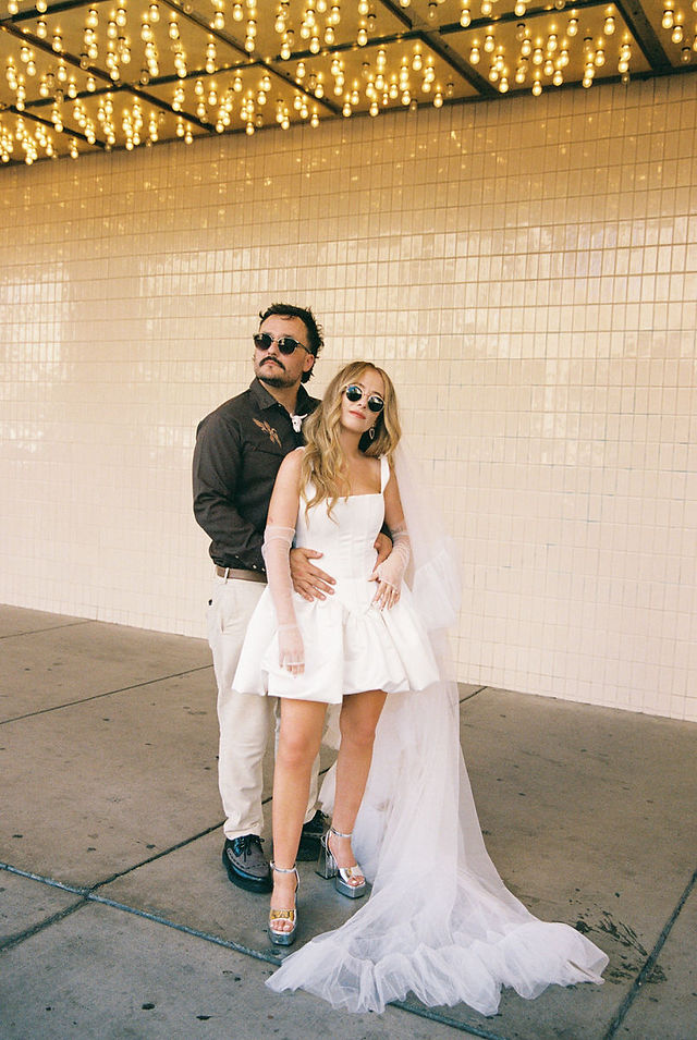 35mm film photo by las vegas elopement photographer brazen honey films. couple takes pictures in downtown las vegas with neon lights and vintage vibes.