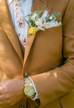 groom wearing brown suit for his elopement in palm springs photographer by wedding photographer in las vegas