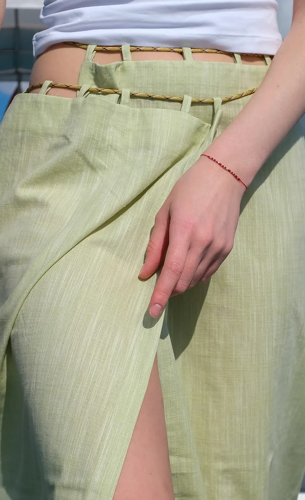 Thumbnail: womens wrap pareo skirt close up view with me like summer rope and loop details on Adini Sen Koy yacht scene