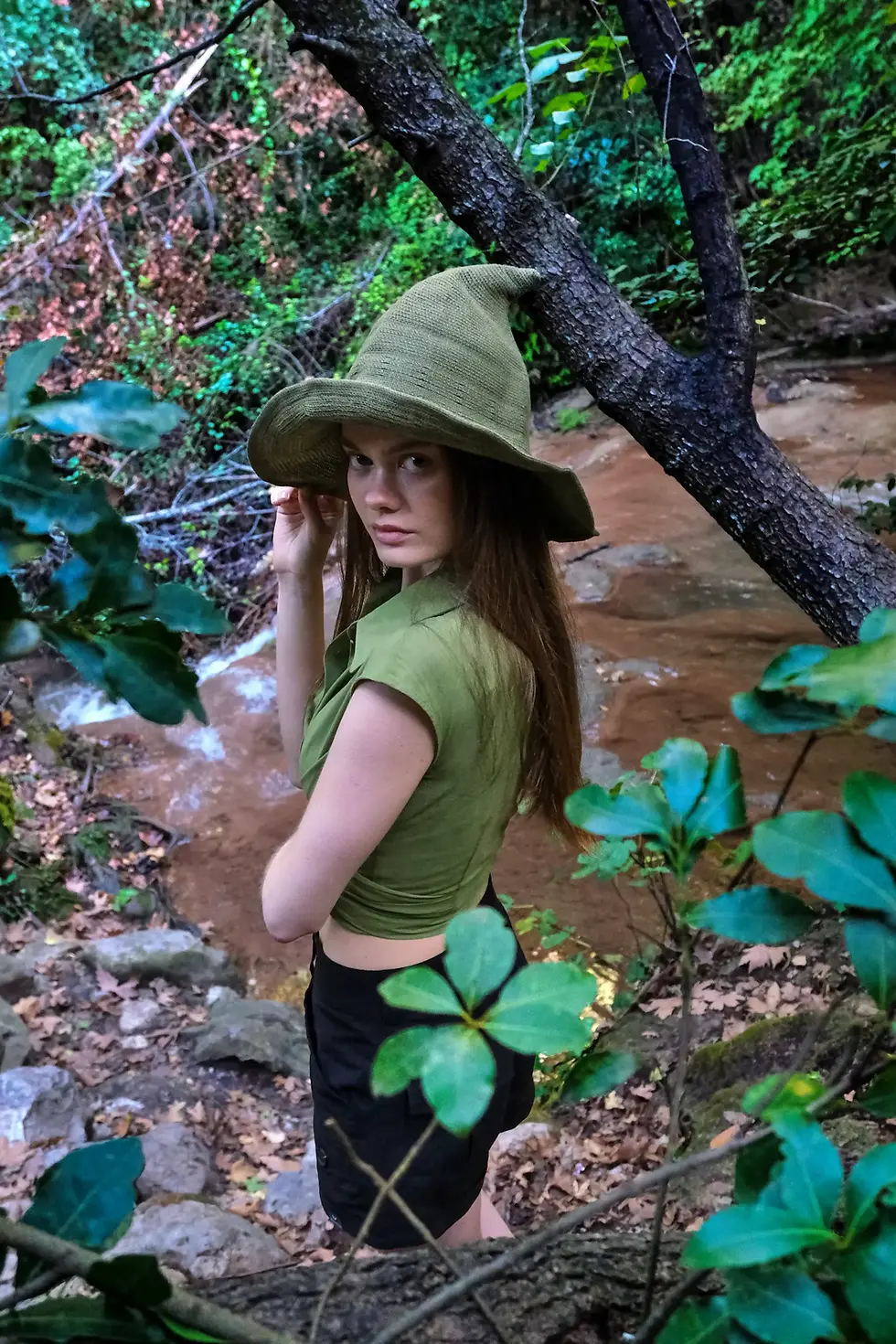 Thumbnail: womens green cap sleeve tie wrap cotton top side view with black shorts