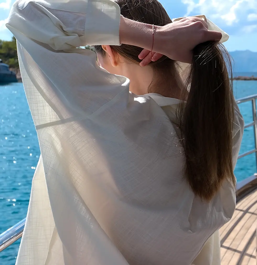 Thumbnail: womens off-white oversize cotton shirt back view with red shorts on Adini Sen Koy yacht scene in Bozburun
