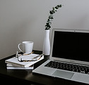 white ceramic mug on white ceramic saucer beside silver macbook_edited.jpg