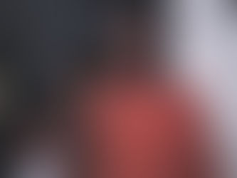 A young Carol and her grandfather pose together hugging on Christmas morning.