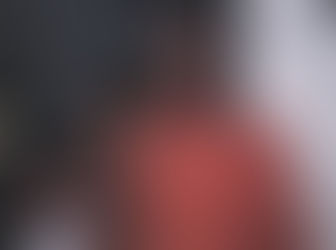 A young Carol and her grandfather pose together hugging on Christmas morning.