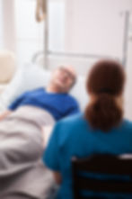 back-view-nurse-sitting-chair-talking-with-pensioner-nursing-home.jpg