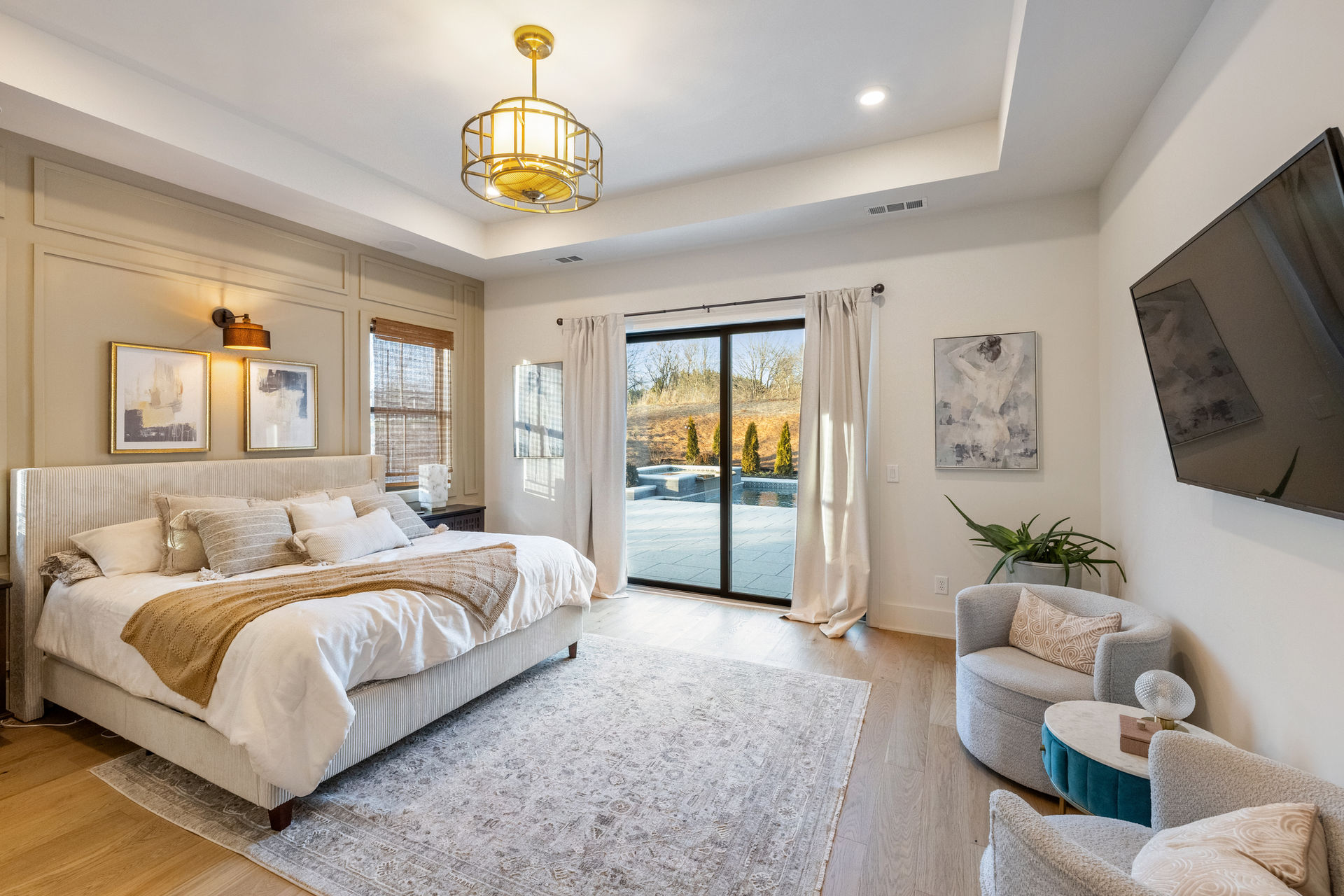 Primary bedroom with tray ceiling and patio doors photographed by North Georgia real estate photographer