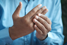A person with joint pain in their hands