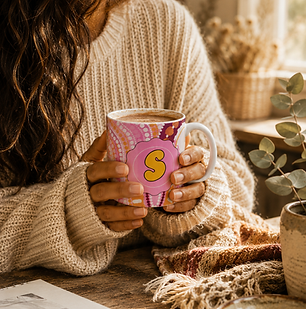 Hands wrapped around a steaming coffee in an Aboriginal art mug featuring the Women's Business design by Ashleigh Pengelly.