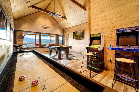 game room with pool table and arcade and other game tables and mountain views
