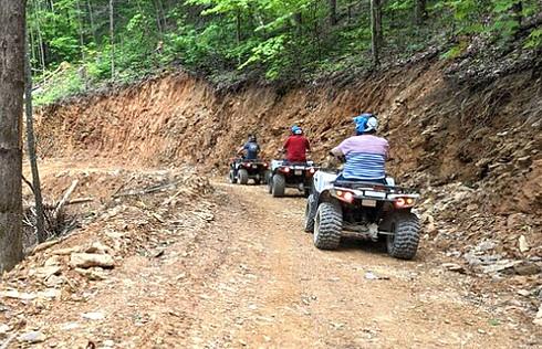 3 people ride ATVs in the Smoky Mountains