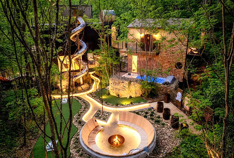 The Hideout Cabin in a forest between Gatlinburg and Pigeon Forge, with unique spiral slide, fiepit, swim spa and unique lighting.