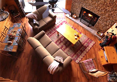 View of living room and fireplace from cabin loft