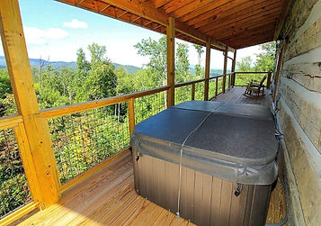 hot tub on deck with mountain view
