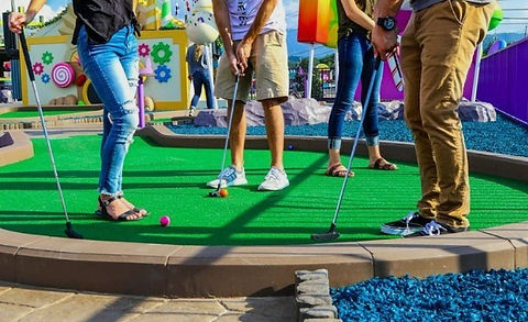 group of people play mini golf