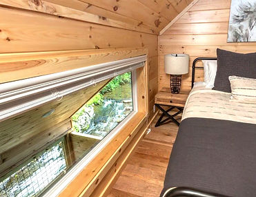window view of rushing stream from loft bedroom of rental cabin in Gatlinburg
