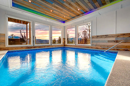 indoor swimming pool with large windows and mountain views