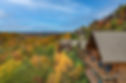 A cabin community perched on the side of the Smoky Mountains in Pigeon Forge, Tennessee, with bright fall foliage and mountain views