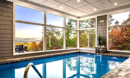 indoor swimming pool with large windows and mountain views