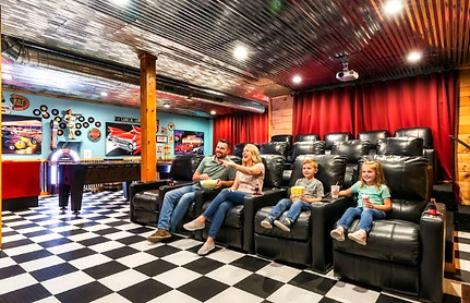 A family enjoys the theater room in a 50's themed cabin in the Smoky Mountains, Tennessee
