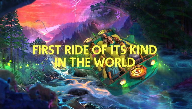 Eye-level view of Dollywood’s new ride, Nightflight, with colorful roller coaster tracks and lush green surroundings