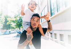 Father walks with child on his shoulders downtown Gatlinburg, TN