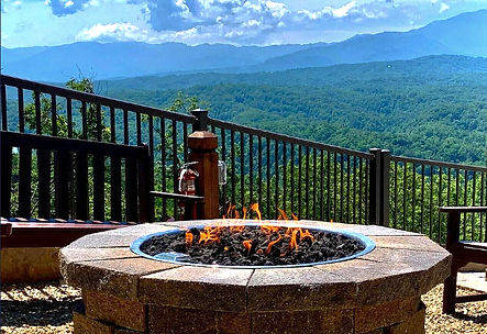 Pretty stone lit fire table on a deck with a Smoky Mountain view