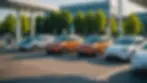 Wide angle view of a fleet of electric vehicles charging at a station