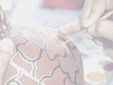 someone painting pottery in  Bisque & Bean