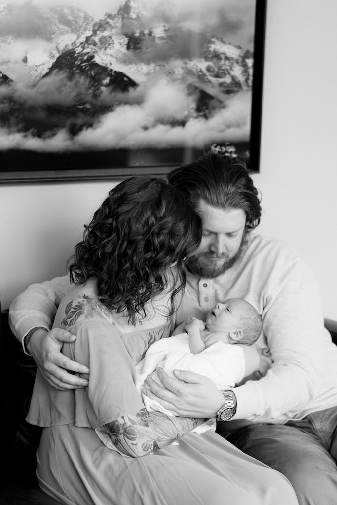 newborn asheville parents holding baby in their home